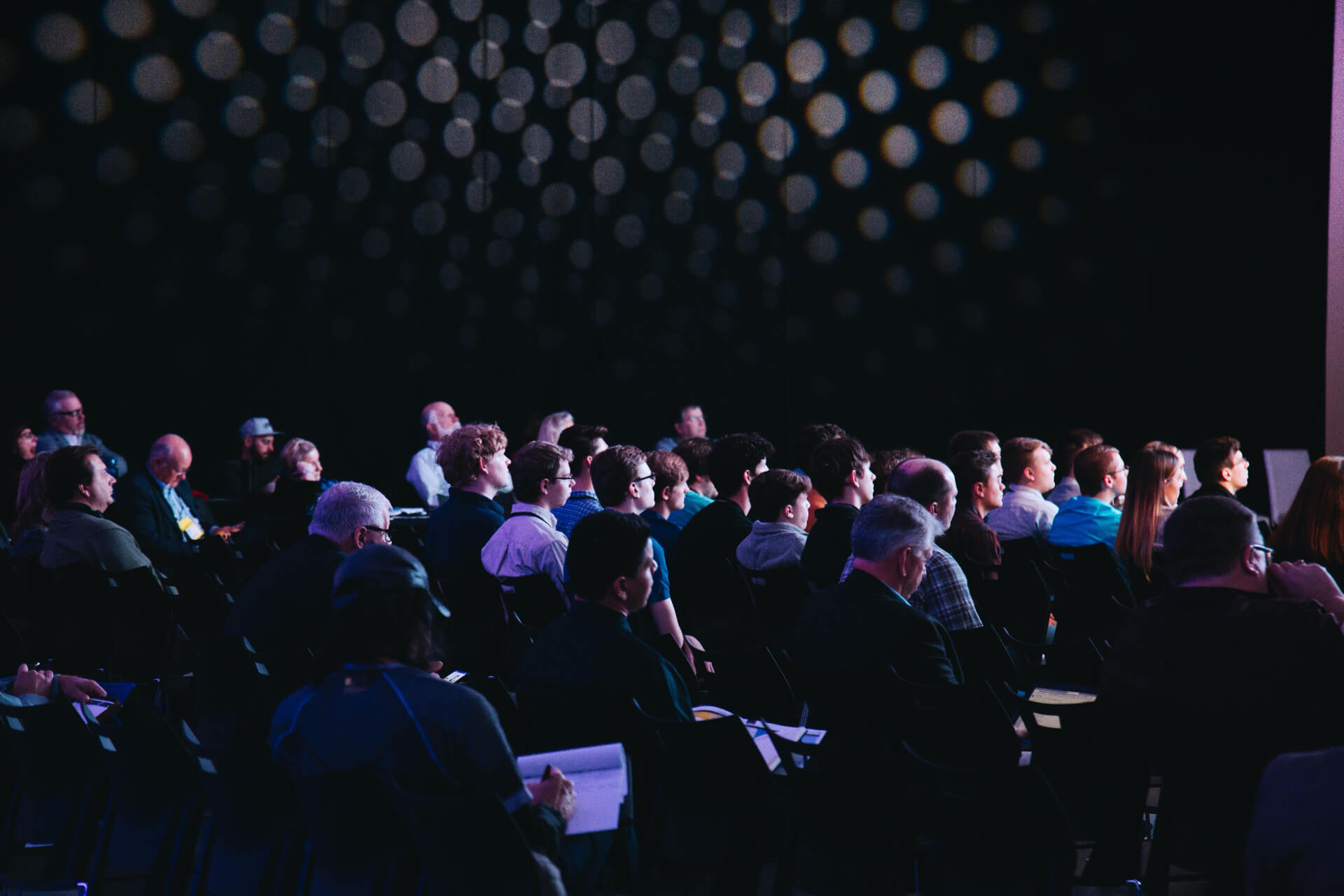 A croud of people sat at a conference